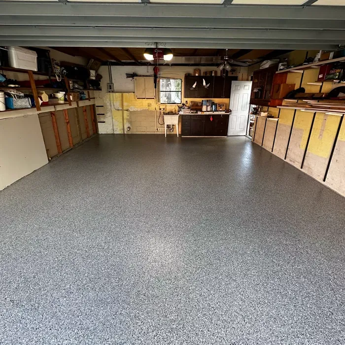 Full-flake garage floor coating beside storage cabinets in Beacon Square, FL