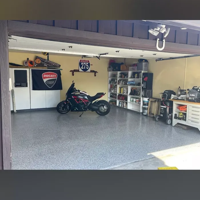 Motorcycle parked on a full-flake garage floor coating in Beacon Square, FL