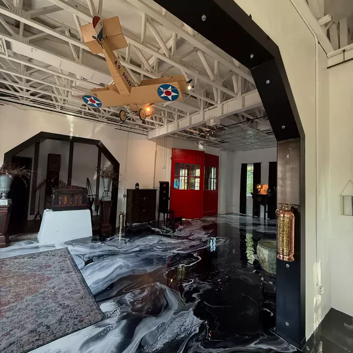 Metallic epoxy flooring with a black marble look in a showroom