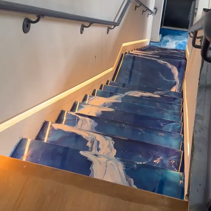 Metallic epoxy flooring flowing down a Tampa, FL staircase