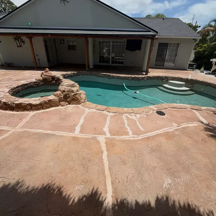 Rejuvenated concrete pool deck with a new coating system