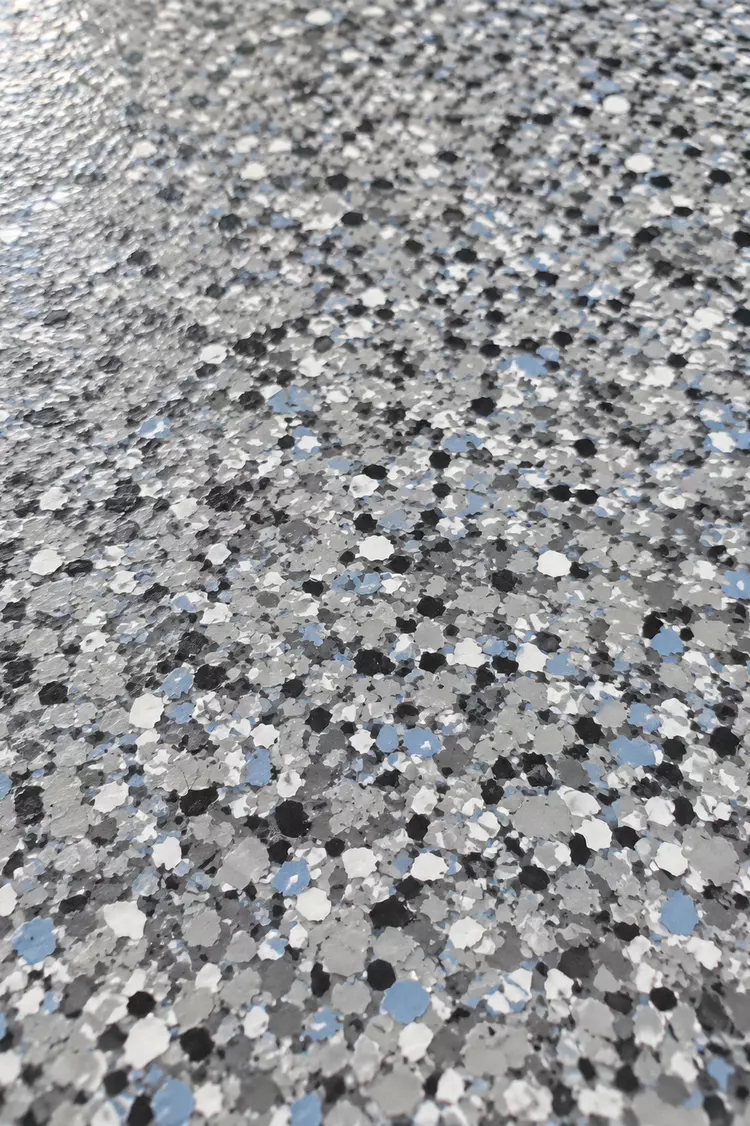 Blue and gray full-flake garage floor coating close-up in Tampa, FL