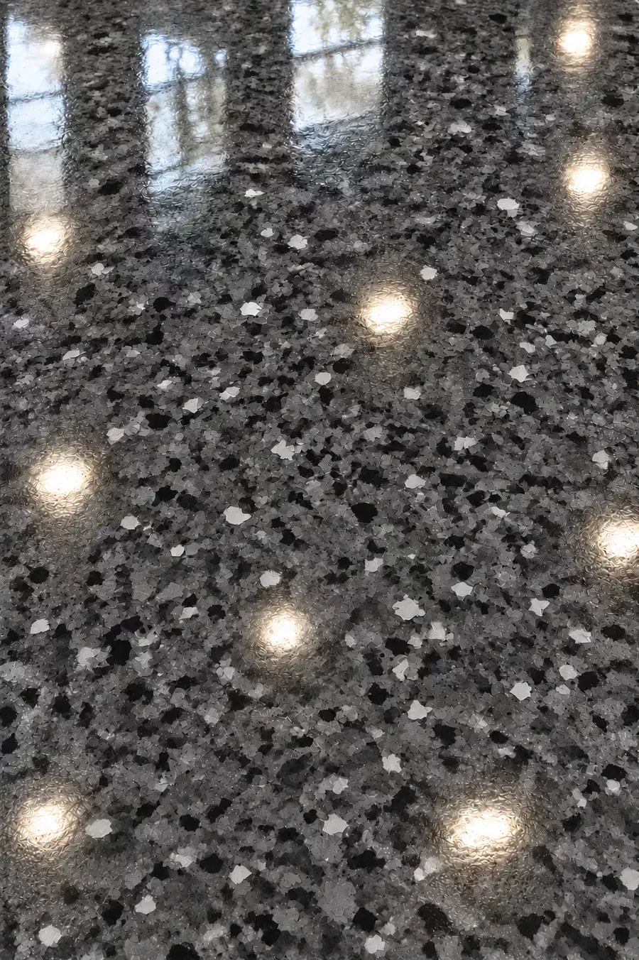 Close-up of a gray flake polyaspartic floor coating in Tampa, FL