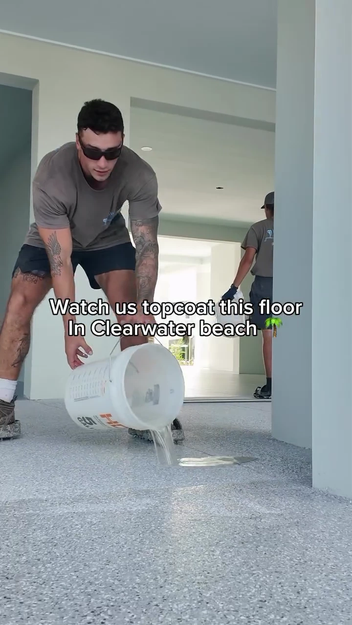 Polyaspartic clear topcoat being applied to an epoxy floor